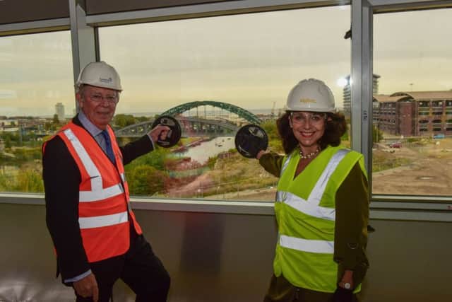 Julie Elliott, pictured at the glazing out ceremony held inside the first building on the former Vaux Brewery site in October, alongside Councillor Harry Truman.