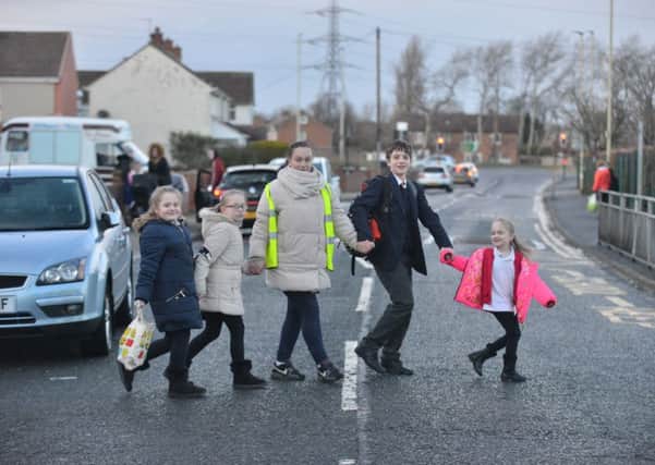 Becky Bailey, acting as school crossing patrol with youngsters   Ruby Kenyon, 9 Emily Kenyon, 11, Aaron Bailey, 14 and Alana Kenyon, 7.