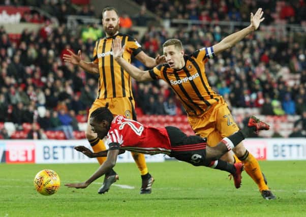Sunderland's Joel Asoro goes down under pressure from Hull City's Michael Dawson, but his penalty appeal was waved away