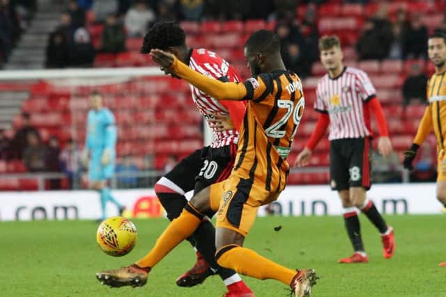 Josh Maja battles for the ball with Ethan Robson looking on.