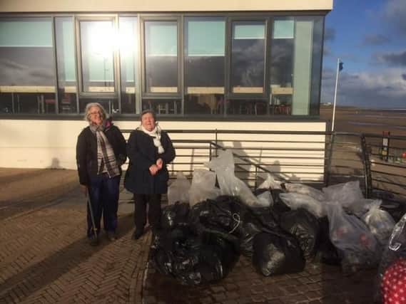 Coun Margaret Beck, right, with Sue Kerton and the rubbish collected by volunteers.