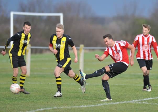 Sunderland West End (red/white) get in a shot against Hebburn Town Reserves on Saturday