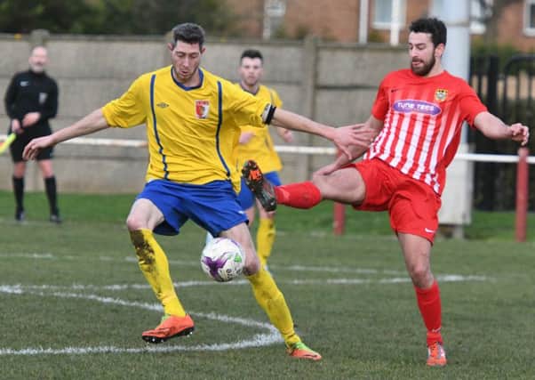 Sunderland RCA defender Greg Swansbury (yellow) comes under pressure against Ryhope CW on Saturday. Picture by Kevin Brady