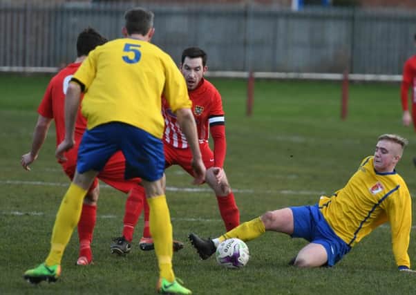 Sunderland RCA's Dylan Elliott (yellow) goes to ground to win possession against Ryhope CW. Picture by Kevin Brady