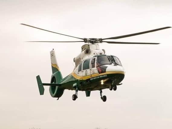 The woman was airlifted to hospital after she was cut free from the frame of a hoist.