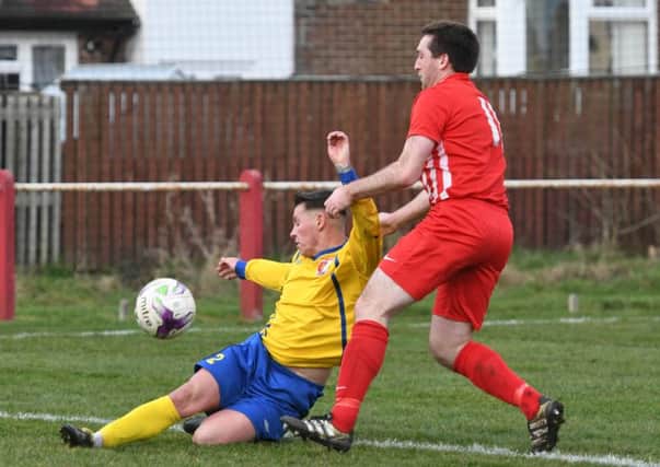 Sunderland RCA's Reece Noble (yellow) moves in to deny Ryhope CW forward James Ellis last weekend. Picture by Kevin Brady