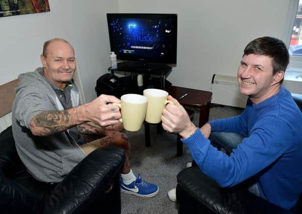 Colin Wootton enjoying a cup of tea with Vic Lane in his newly-rented flat.