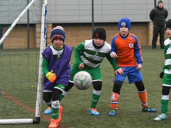 Russell Foster Youth League action at East Durham College, Peterlee. Birtley Town Juniors u10s, green and white, take on Dalton Park Rangers u10s, orange and blue.
