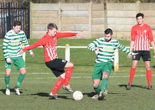Silksworth CW (red/white) battle in vain against Clewator Moor Celtic on Saturday. Picture by Kevin Brady