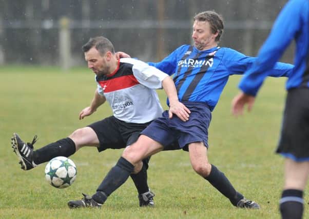 Over-40s action as Washington Victoria Inn (blue) take on Redhouse WMC last weekend. Picture by Tim Richardson