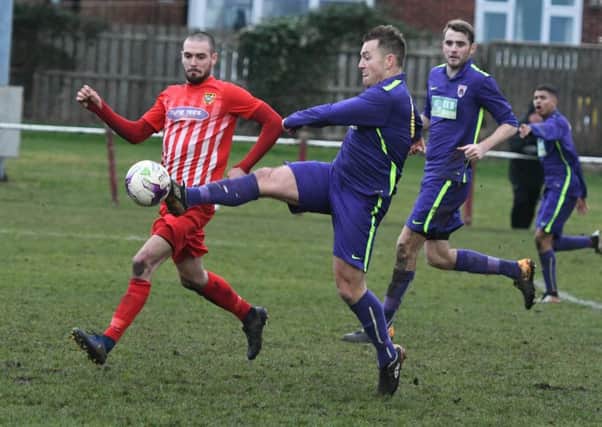 Guisborough Town deny Ryhope CW striker Josh Home-Jackson an opening in Saturday's Division One clash. Picture by Kevin Brady