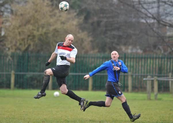 Over-40s action as Washington Victoria Inn (blue) meet Redhouse WMC last week. Picture by Tim Richardson