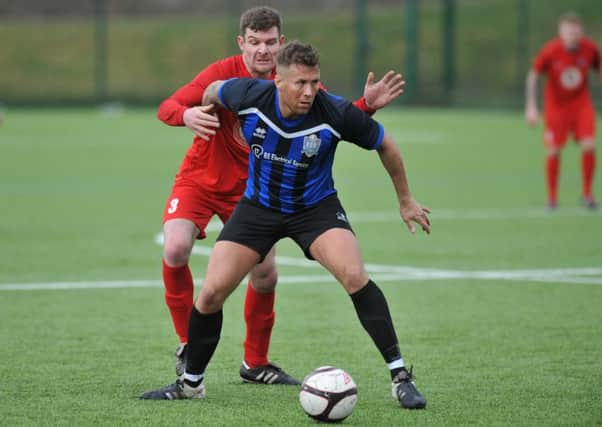 Peterlee Catholic Club (blue) scrap against Victoria Gardens in last week's Durham Sunday Cup quarter-final. Picture by Tim Richardson.