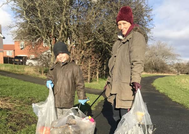 Kirsty and Gaius Dalton picking up rubbish near their Sunderland home.