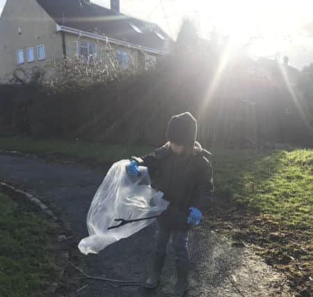 Gaius Dalton picking up rubbish near his Sunderland home.