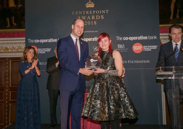 Zinnia Young is presented with her award by Prince William