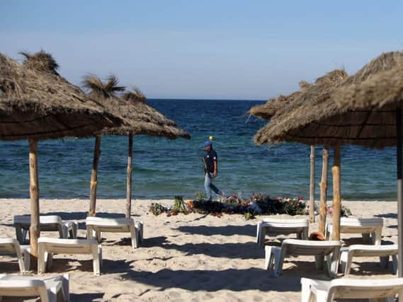 An armed policeman on the beach in Sousse, Tunisia, following the June 2015 terrorist attack at the beach.  Pic: PA.
