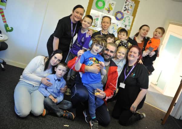Laura Robson, front left, with son Marc, who is organising a charity night for Include 'In' Autism, pictured with other visitors to the service.