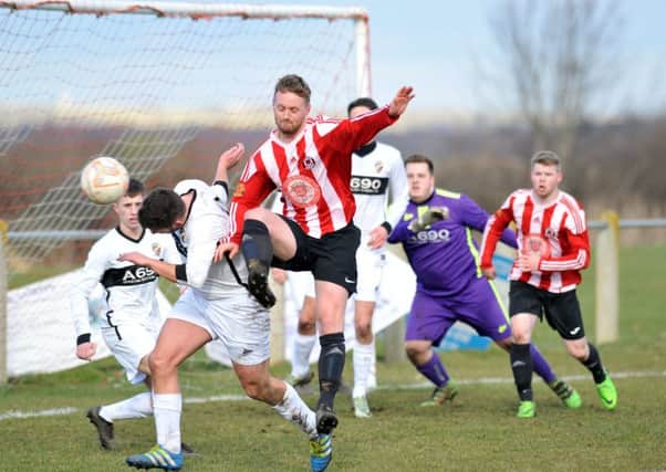 Sunderland West End (red/white) attack against Coxhoe Athletic on Saturday. Picture by Tim Richardson