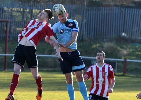 Sunderland RCA's Luke Page (red/white) battles for a ball in the air against North Shields at Meadow Park on Saturday. Picture by Kevin Brady