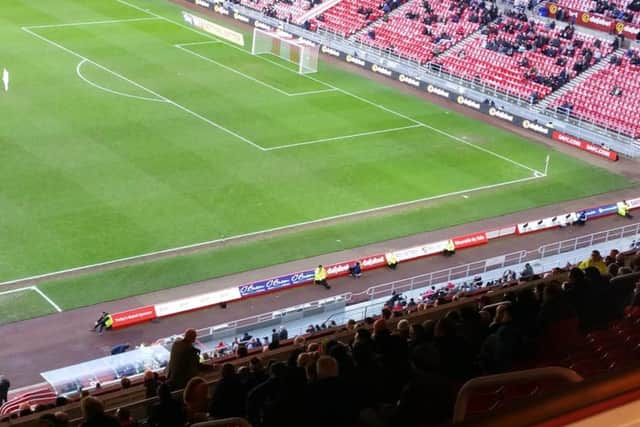 A Sunderland fan (stood up) shouts at Sunderland chief executive Martin Bain midway through the second half.
