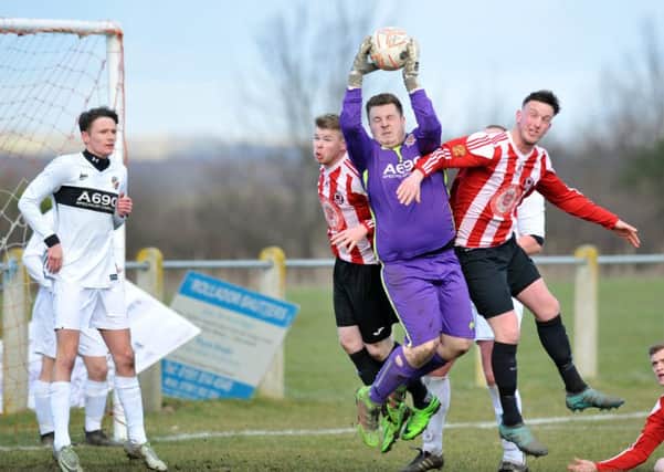 Coxhoe Athletic keeper Jack Elcoat gathers a high ball under pressure at Sunderland West End last week. Picture by Tim Richardson.