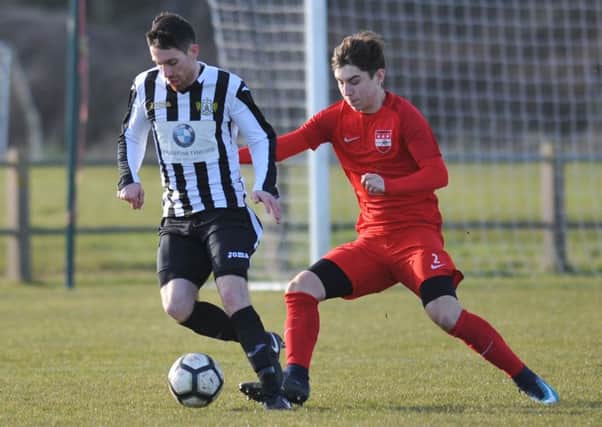 Washington (red) battle against Ashington in Division One on Saturday. Picture by Tim Richardson