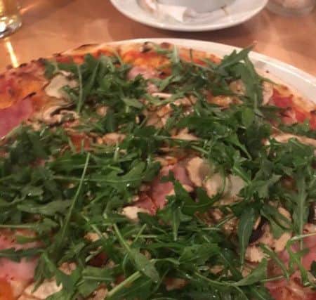 Prosciutto funghi pizza with added rocket