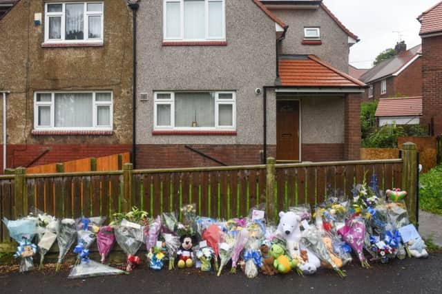 Flowers outside the house in Falkland Road, Ford Estate, Sunderland, where three-week-old Reggie Young was mauled by a dog in June 2015.