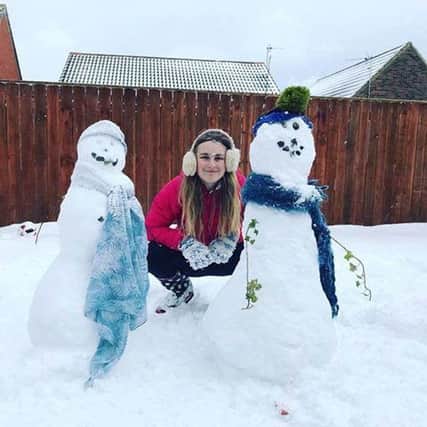Sent in by Alison Foster.  Posing with the snowmen.