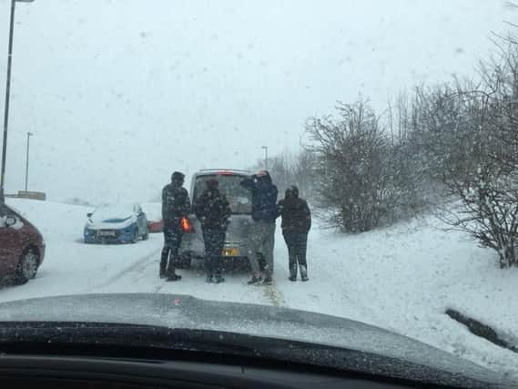 Funeral director Martin Morrell took this photo of people braving the elements to help push the hearse.