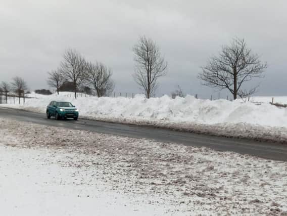 Drifiting snow is piled up beside the road on the A183 at Penshaw.