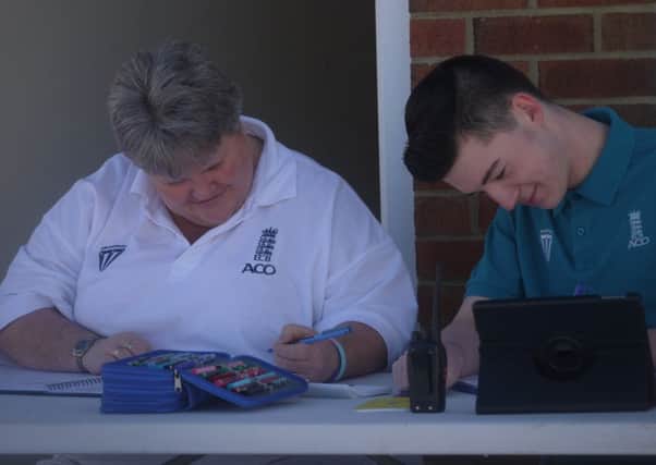Cricket scorers try out the new programme.