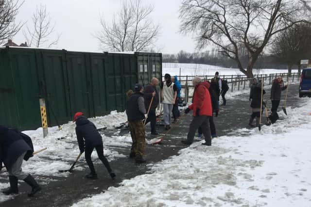 Volunteers help clear snow at Thornhill Academy. Credit: Ian Redford.