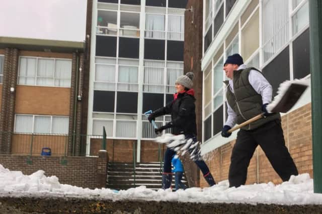 Volunteers help clear snow at Thornhill Academy. Credit: Ian Redford.
