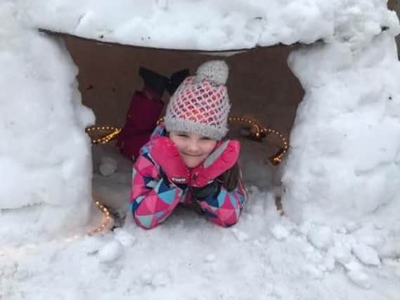 Camille Stokes takes shelter in her igloo.