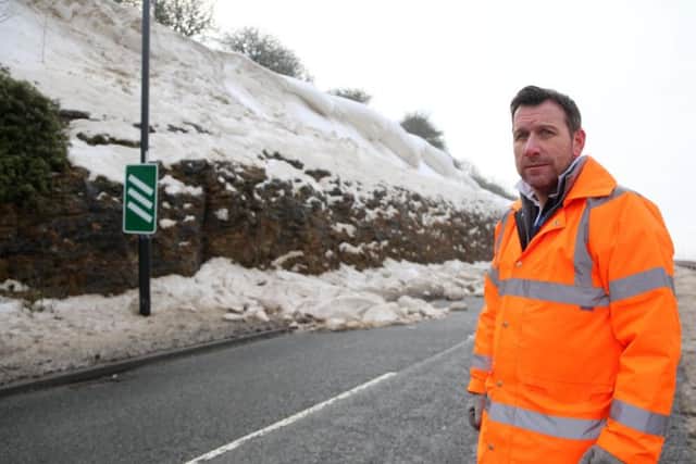 Ian Richardson, assistant head of place management Sunderland city council, with the large snow drift that has shut the west-bound A690 near Houghton. Picture: TOM BANKS