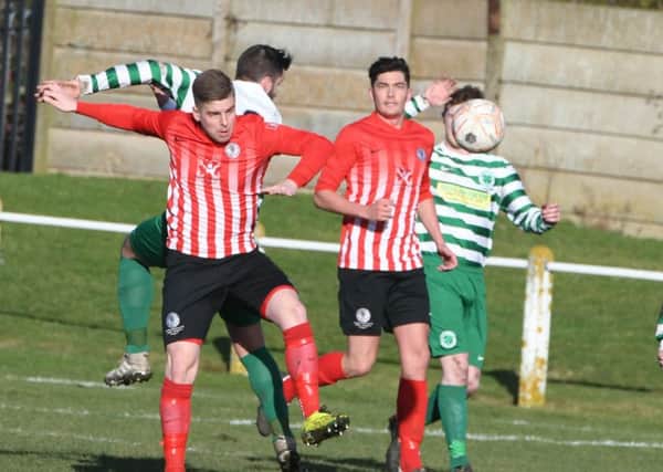 Silksworth CW (red/white) take on leaders Cleator Moor Celtic last month.