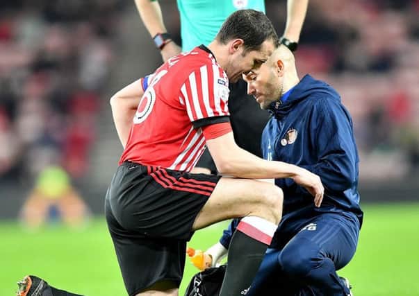 Sunderland captain John O'Shea receives treatment last night against Aston Villa.
