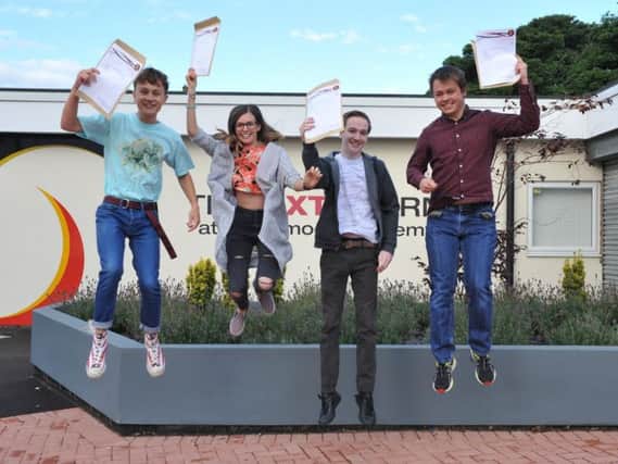Students Michael Beattie, Beth Cutting, Andrew Galloway, and Adam Liddle, celebrate their A Level results at Southmoor Academy last summer.