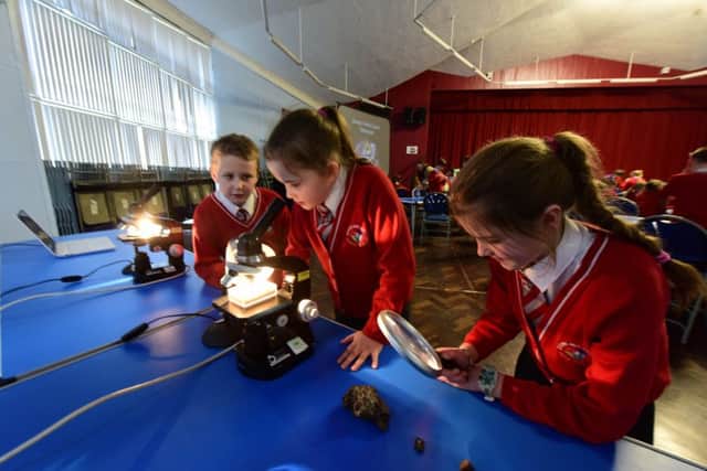 The Planetarium at Thornhill Academy, Sunderland, with the help of The Kielder Observatory. Looking at samples of meteorites are l-r James Arthur Scott, Leona Dannielle and Demi Leigh Ross