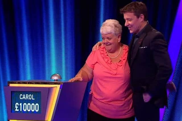 Carol Kelly celebrates her win with Tipping Point host Ben Shephard