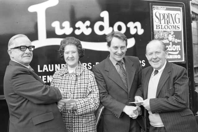 Salesmen Jim Trotter, left, and Arthur Graham, right with Florence Howey, joint managing director, and chairman J K Lumsden-Taylor.