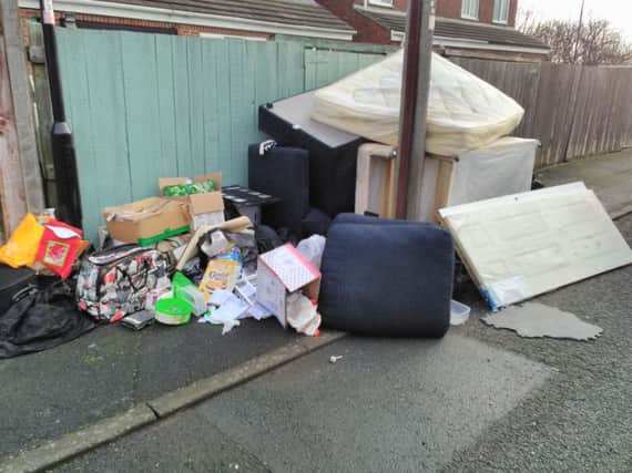 The uncollected waste at the rear of Moir Terrace