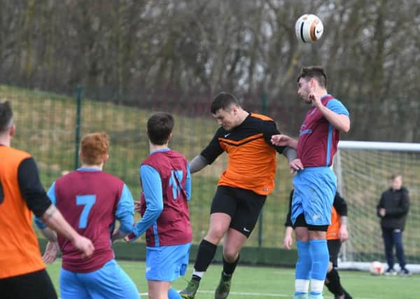 Park View (orange/black) battle it out with Ryhope (claret/blue) last weekend. Picture by Kevin Brady