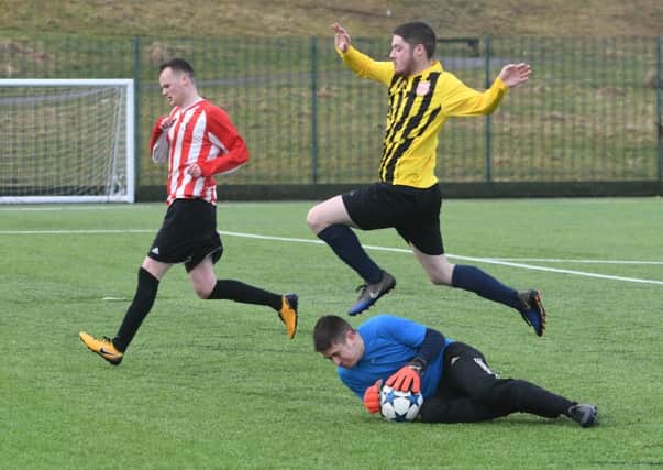 Lakeside SSC's keeper claims the ball as Millfield Free Gardeners (yellow/black) attack in last week's Sunderland Sunday League clash. Picture by Kevin Brady