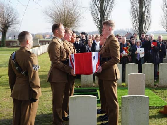 Riflemen from the 3rd Battalion, the Rifles, prepare to lower the coffin of Private Edmundson