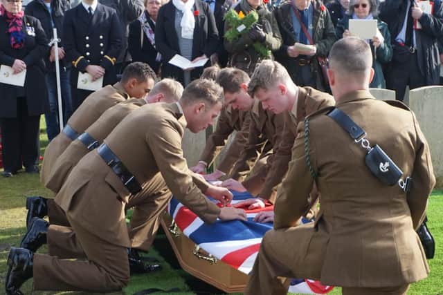 Riflemen from the 3rd Battalion, the Rifles, carefully fold the ceremonial Union Flag in honour of Private Edmundson