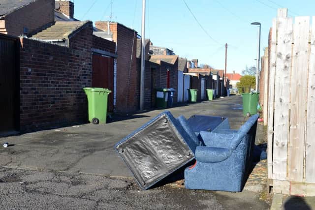 Bins and flytipping left in the back street of Empress Street and Ross Street in Southwick.