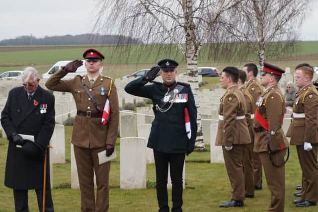 Captain Matt Tovey, Senior Officer representing Royal Anglians, left, and Rob Thompson, Defence Attach, British Embassy salute in front of the Royal Anglians.